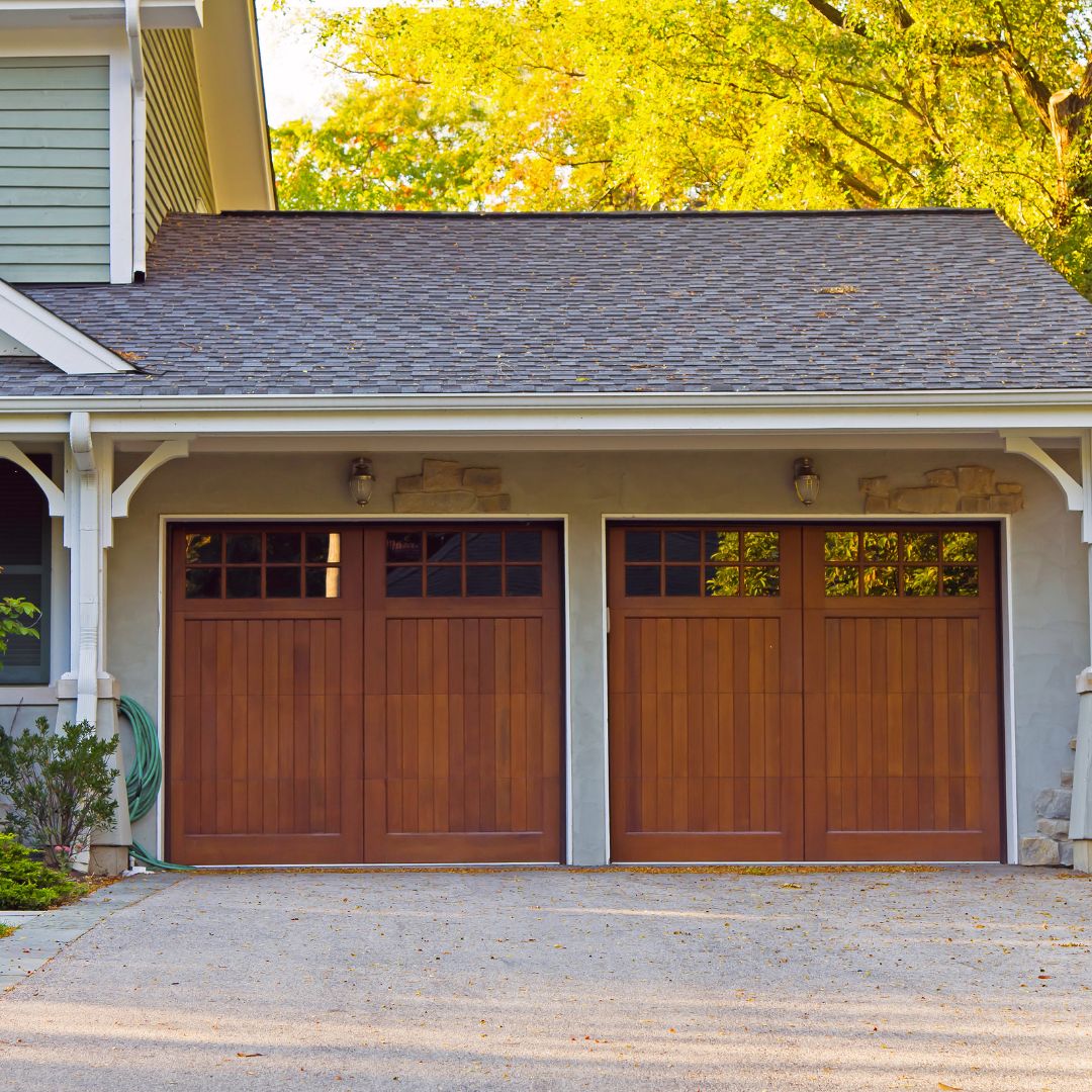 Home with 2 door garage and lights above the garage doors