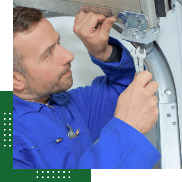 technician repairing a garage door